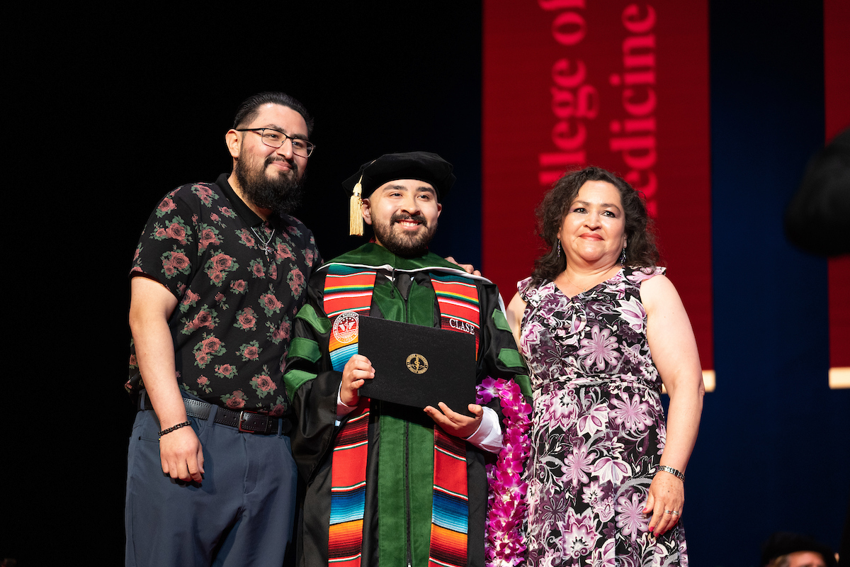 A group of people posing for a photo at a graduation ceremony.