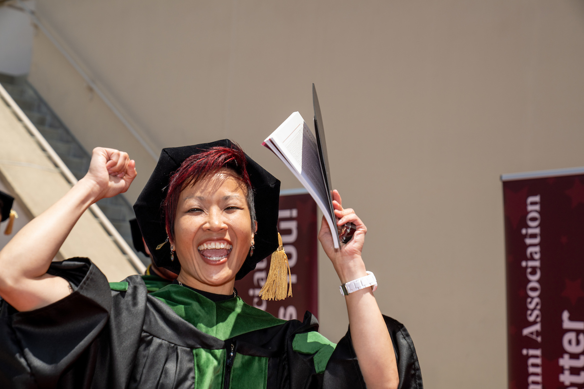A woman in a graduation gown.