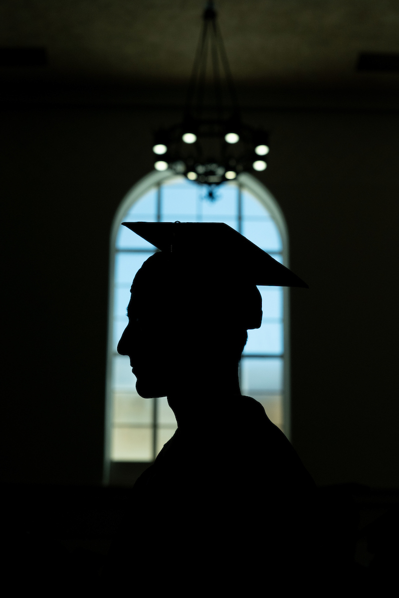 A silhouette of a person in a graduation cap.