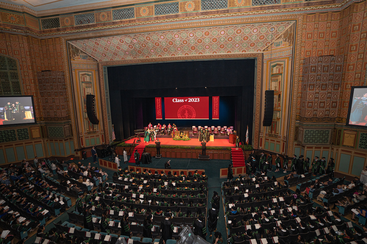 A large auditorium with many people in it.