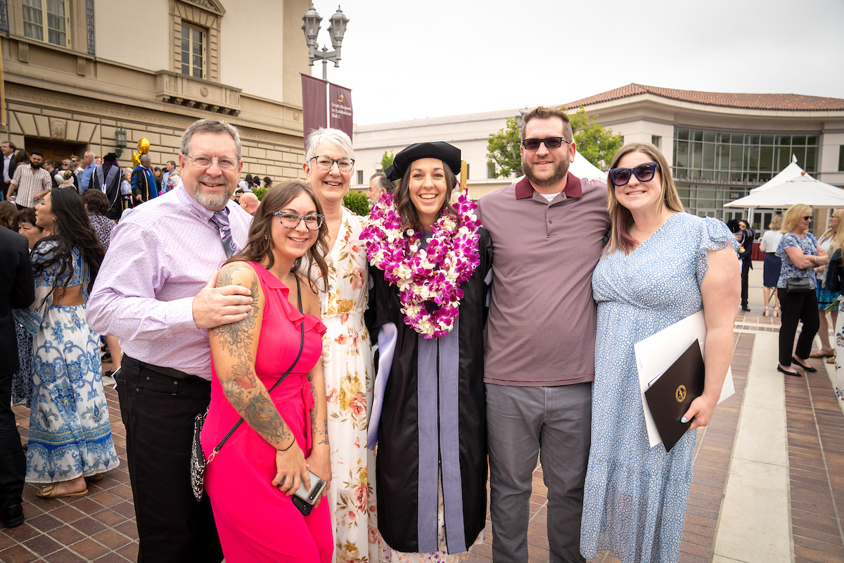 A group of people posing for a photo in front of a building.