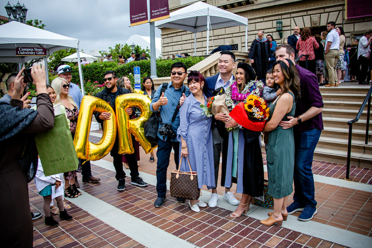 A group of people posing for a photo with balloons.