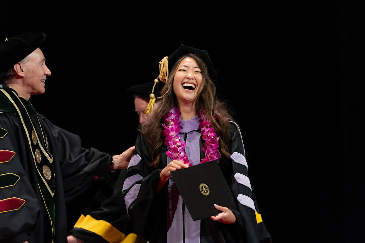A woman in a graduation gown.