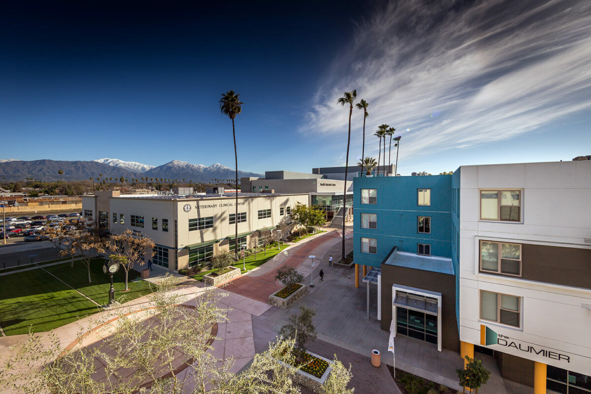 An aerial view of a campus with mountains in the background.