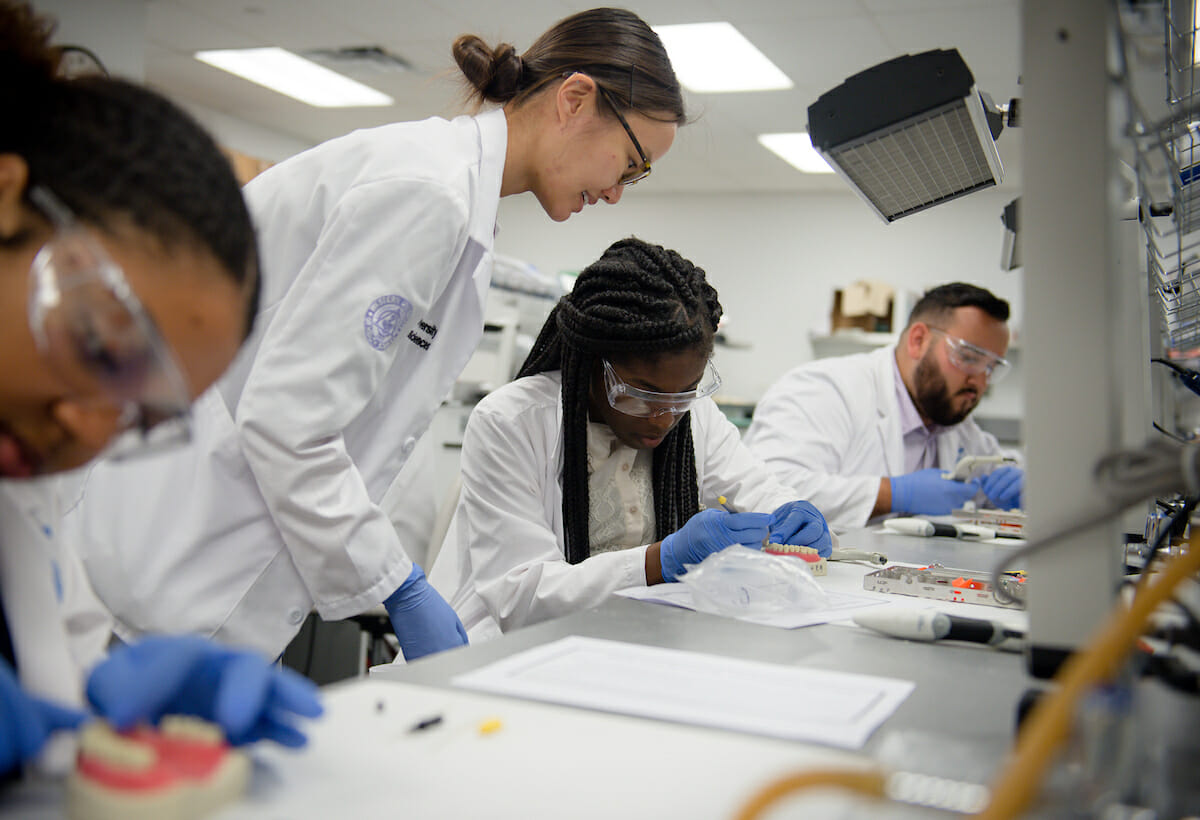 WesternUSHPEP students learn to sculpt a fractured typodont tooth with composite during a dental medicine rotation.