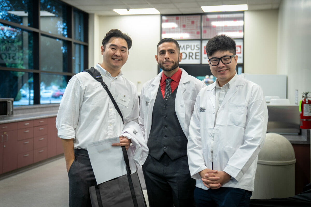 Three students men posing for a photo.