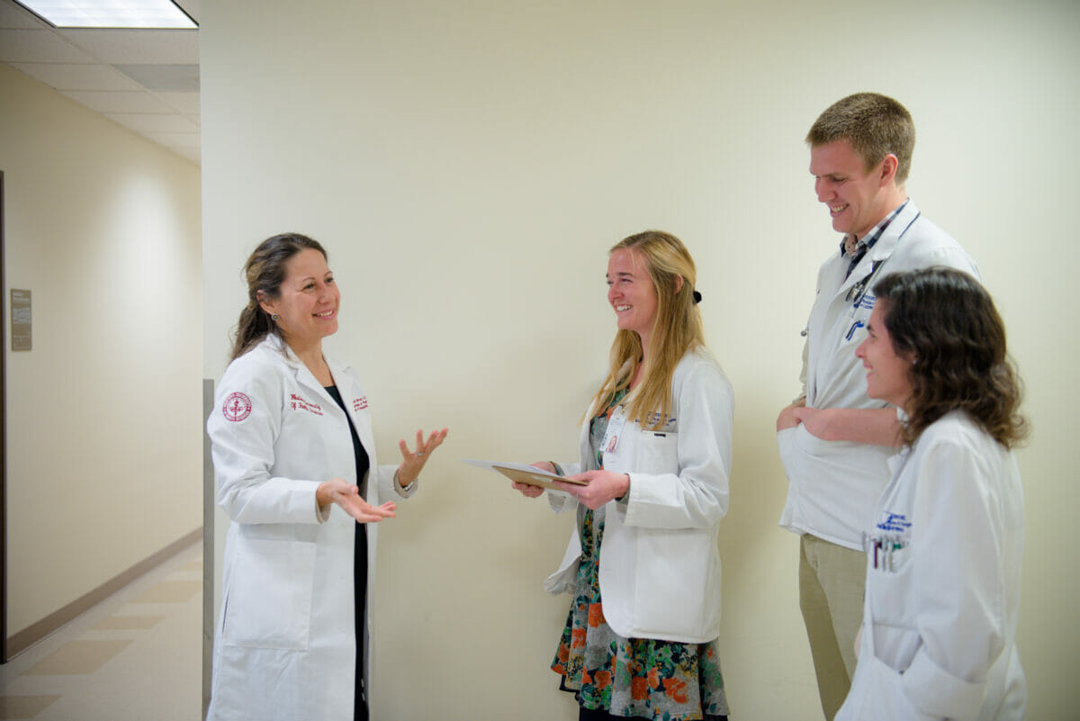 Four students in white coats