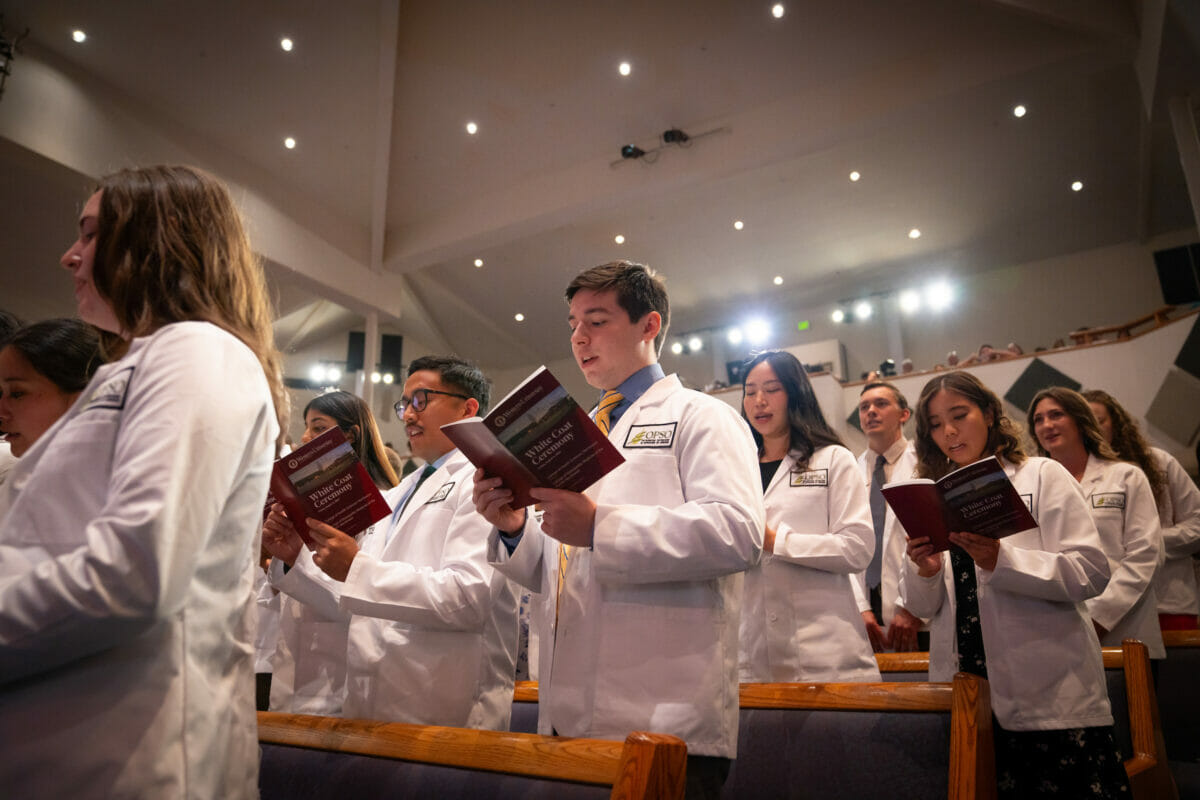 Group, white coats, church.