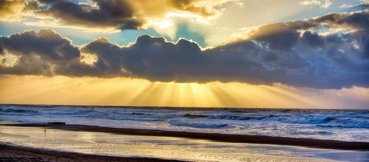 Photo of horizon with sun behind the clouds