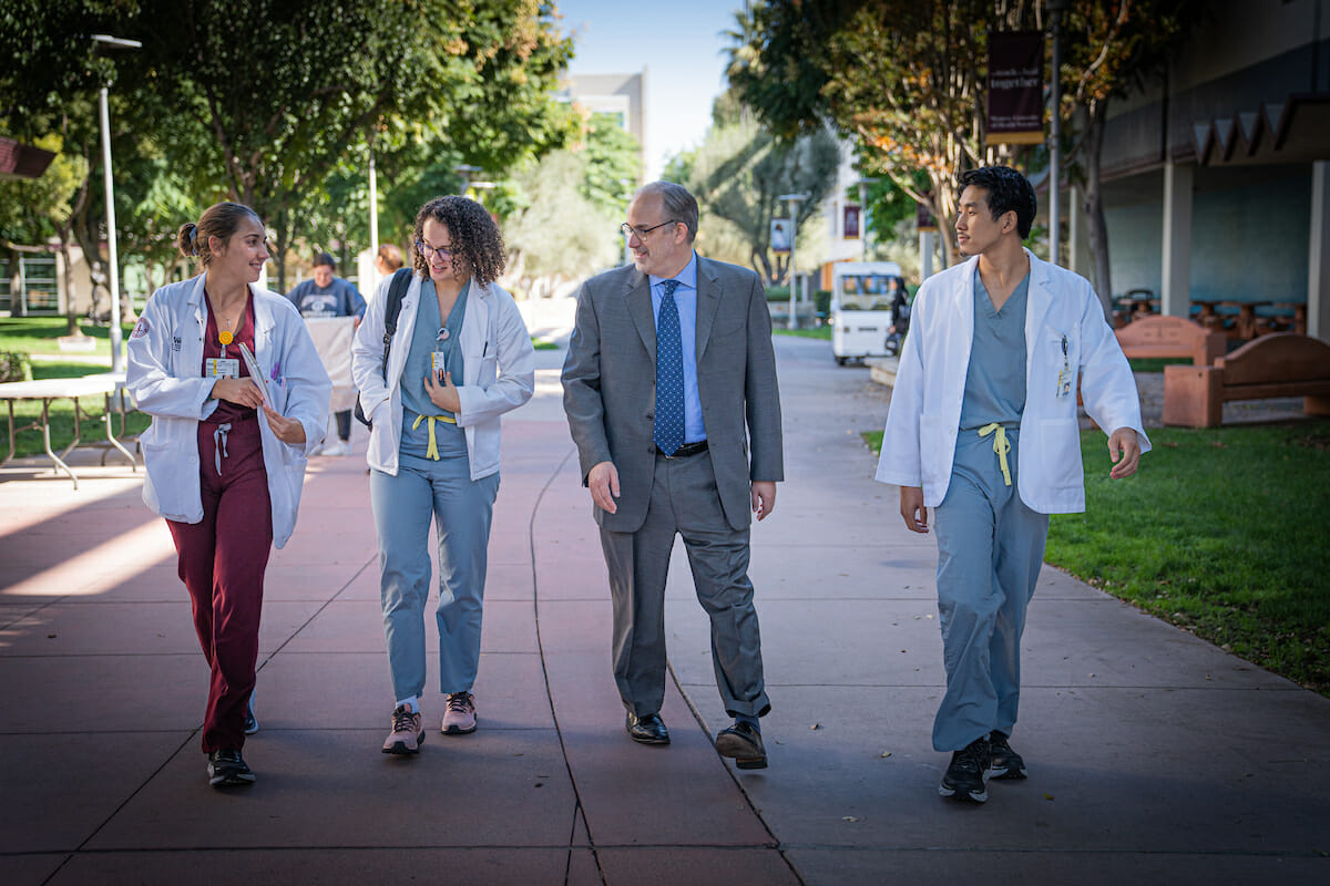 Newly-appointed Dean Labovitz engages with students as they walk down the esplanade