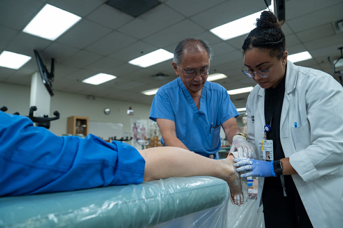 College of Podiatric Medicine Professor Stephen Wan, DPM, provides instruction and insight on orthotic casting to third-year CPM student Bailey Morgan during a Clinical Skills Workshop