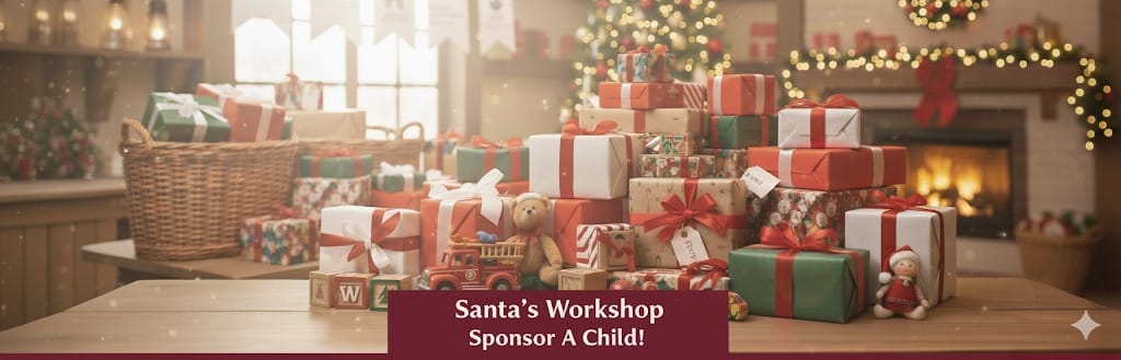 Stacks of wrapped Christmas presents and toys on tables, with festive decorations and a fireplace in the background. Text reads: "Santa's Workshop Sponsor A Child!.