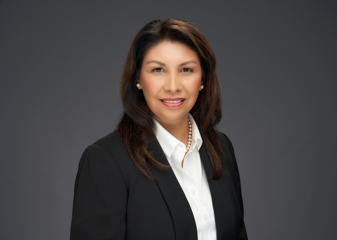 A woman in a business suit posing for a photo.