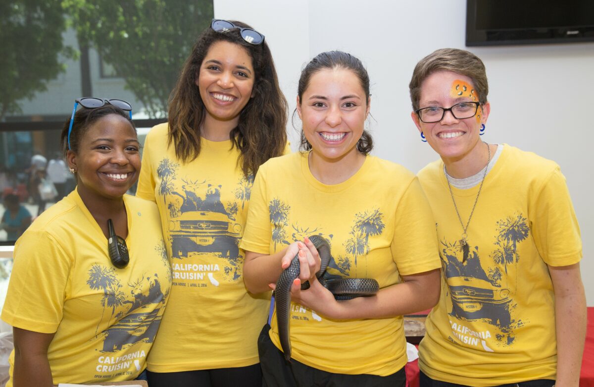 A group of women wearing yellow t - shirts.