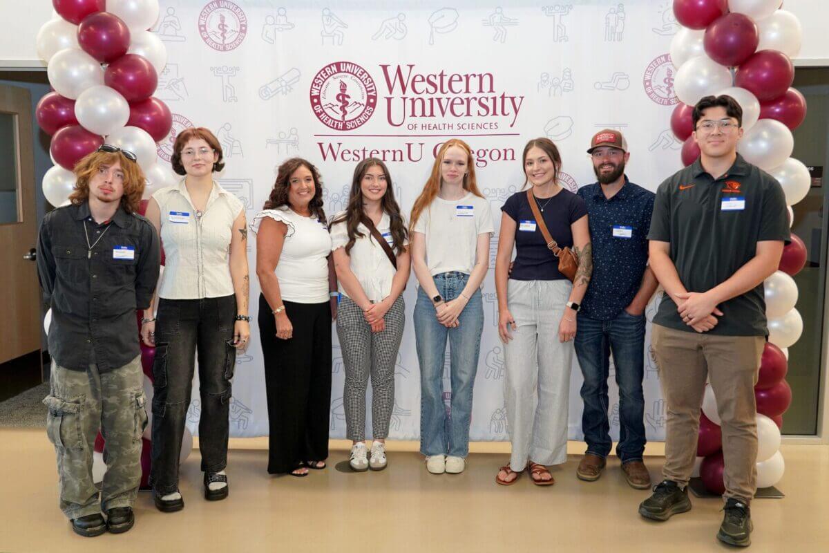 Students standing in front of a banner